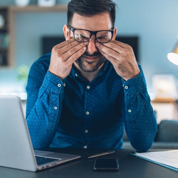 guy rubbing his eyes