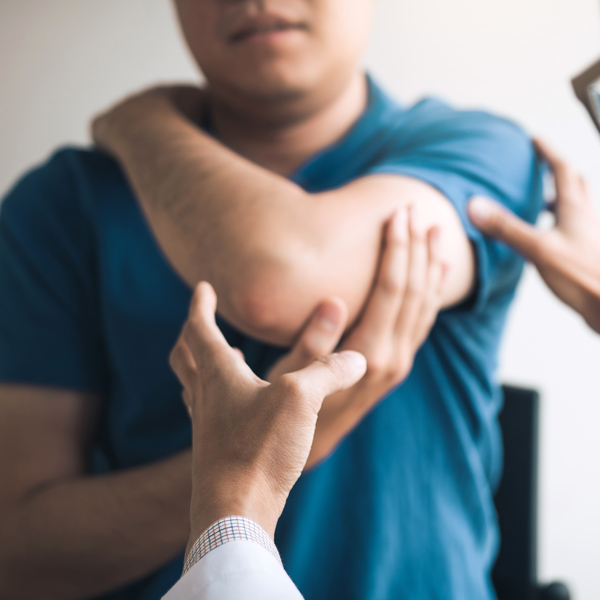 man getting arm examined