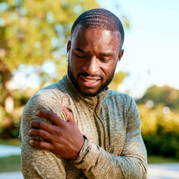 man grasping shoulder